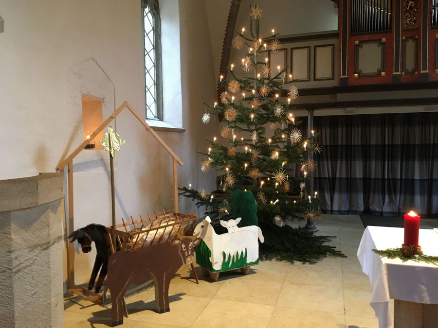 Große Krippe in der Kirche vor Weihnachtsbaum